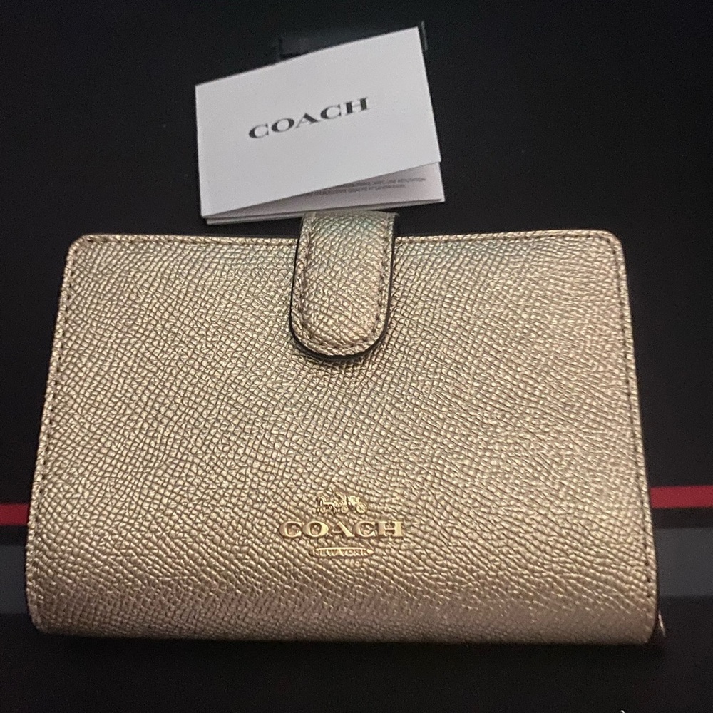 Brand new never used and smoke free Coach woman’s wallet with coin pouch.